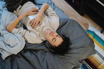 Young man lying down with headphones